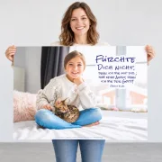 Frau hält das DIN-A1-Poster zur Jahreslosung 2027 quer vor sich und zeigt dessen Größenverhältnis