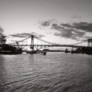 Monumentale Stahlbrücke im hellen Gegenlicht.